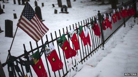 A US flag hangs over stockings left as a memorial for victims of the Sandy Hook Elementary School shooting, 27 December 2012