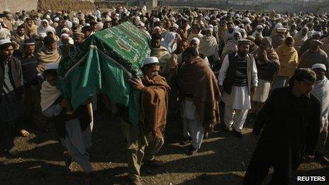 People carry the coffin of an aid worker who was killed by unidentified gunmen, during her funeral in Swabi January 2, 2013.