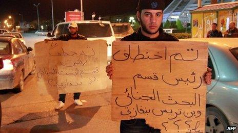 Libyan policemen in civilian clothing protest against the kidnapping of the Head of Criminal Investigation Department, Abdel Salam al-Mahdawi, outside the Tibesti hotel in Benghazi, on January 3, 2013.