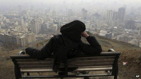 Iranian woman looks on at the smog covering Tehran, Iran, on 4/1/13