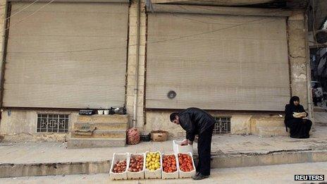 A man sells vegetables on the streets of Aleppo, file pic from 25 December 2012