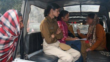 Rukhsana (right) being questioned by police after being rescued