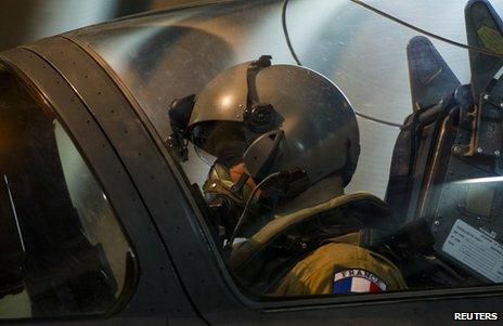 The pilot of a French Mirage 2000D jet sits in the cockpit at a base in Ndjamena, Chad, 12 January