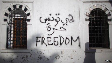 File photo of graffiti at a government building during a protest in Tunisia on 21 January 2011 a week after former President Zine al-Abidine Ben Al fled