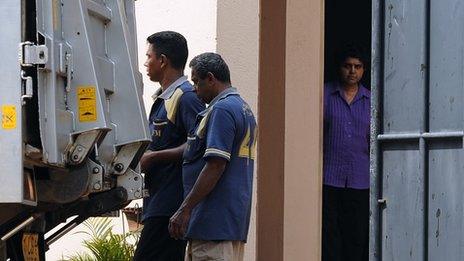 Sacked Sri Lankan chief justice Shirani Bandaranayake (R) looks out from the front door of her private residence in Colombo January 15, 2013