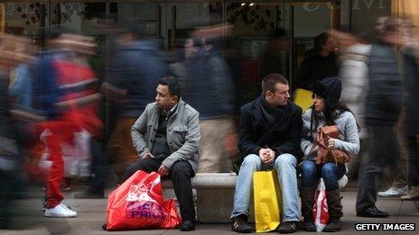 Shoppers rest on a busy Oxford Street in London during the Boxing Day sales