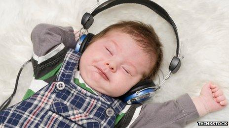 A baby with headphones on