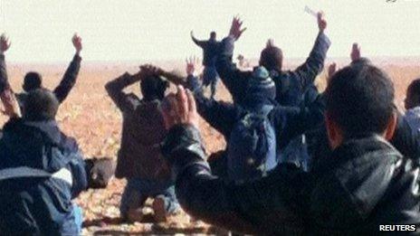 Hostages are seen with their hands in the air at the In Amenas gas facility in this still image taken from video footage taken on 16 or 17 January 2013