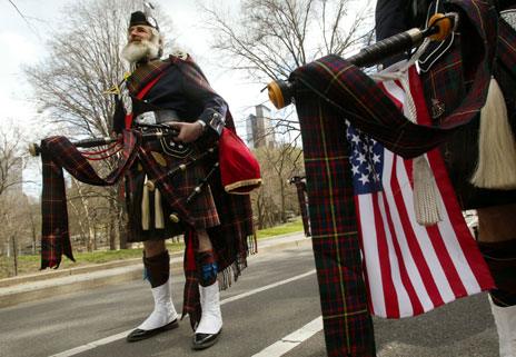 Pipers in kilts with US flags