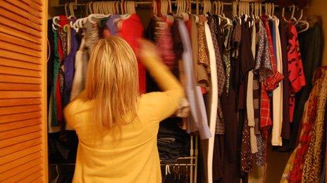 Jillian Rae Greenwood in Ottawa, Canada looking through her wardrobe deciding what to wear