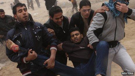 Wounded protester is carried during clashes with security forces in Fallujah, on 25/1/13