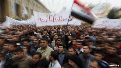 Iraqi Sunnis wave an Iraqi national flag during an anti-government demonstration in Baghdad, 25 January 2013