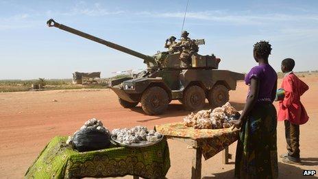 Malian people watch French troops in Diabaly on 23 January 2013