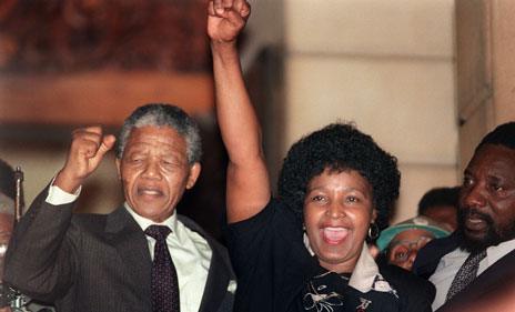 Nelson Mandela and his then wife raise their fists in celebration as he left prison