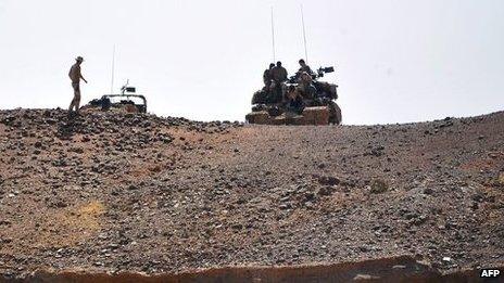 French soldiers stand guard near a bridge on the Niger river in Gao, 3 February 2013