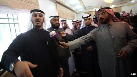 Former Kuwaiti MPs Bader al-Dahoum (Left) and Falah al-Sawwagh (2nd Left) stand with supporters before hearing the verdict (5 February 2013)