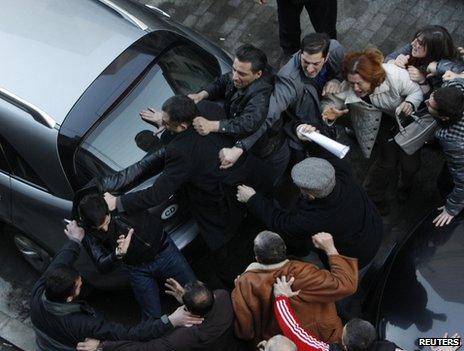 Demonstrators scuffle outside the national library in Tbilisi, 8 February