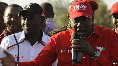Uhuru Kenyatta (right), addresses supporters beside running mate William Ruto during a political rally in Nairobi on 13 February 2013