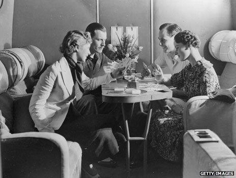 Passengers drink and play cards in the luxury of an Imperial Airways cabin (1936)