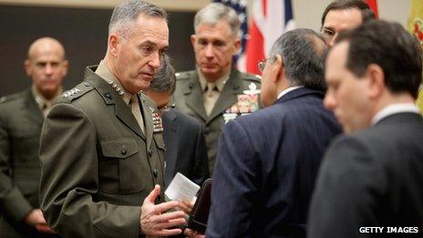 General Joseph Dunford Jr (centre) talks to US Defence Secretary Leon Panetta after they arrive at the Nato headquarters in Brussels 21 February 2013