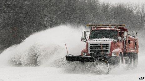 A snow plow clears a part of I-70 in Topeka, Kansas 21 February 2013