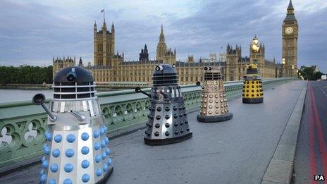 Four generations of Daleks crossing Westminster Bridge in London