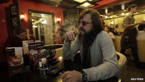 A man smoking a cigarette in a cafe in Siberia