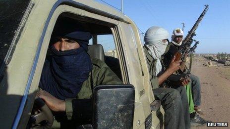 Soldiers from the Tuareg rebel group MNLA ride in a pickup truck in the north-eastern town of Kidal on 4 February 2013