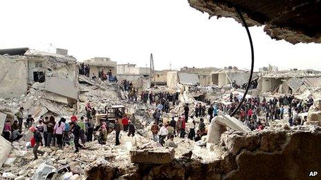 People search rubble for bodies in an area of Aleppo reportedly destroyed by a government missile strike