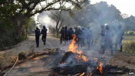 Bangladeshi police stand guard in a street during a clash with Jamaat-e-Islami activists in Thakurgaon, north-west from Dhaka, on February 28, 2013