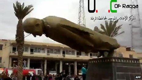 Image grab of YouTube footage purportedly showing Syrian opposition protesters destroying a statue of ex-President Hafez Assad in Raqqa on 4/3/13