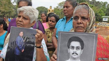 Sri Lankan Tamil women hold up photographs of their missing sons during a protest against the Sri Lankan government in Colombo on Wednesday (6 March 2013)