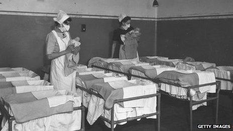 1st December 1947: Nurses holding babies in a maternity ward at Guy's Hospital, London