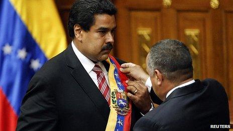 Nicolas Maduro receives the sash of office from National Assembly Speaker Diosdado Cabello