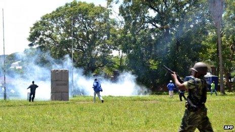 Police fire tear gas at supporters of Former Foreign affairs minister during a demonstration in Blantyre on March 11, 2013.
