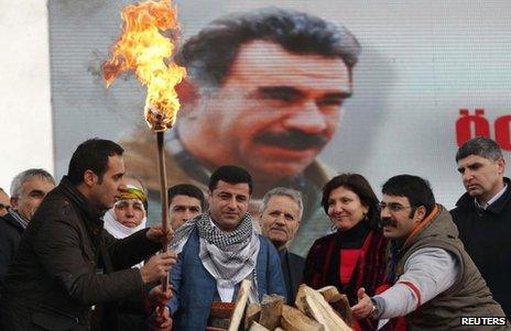 People celebrate the Kurdish New Year in Istanbul in front of an image of PKK leader Abdullah Ocalan, 17 March