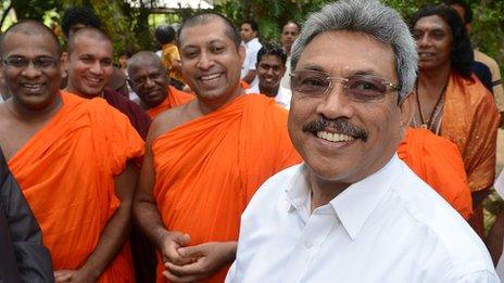 Sri Lanka's Defence Secretary Gotabhaya Rajapakse (R) stands near Buddhist monks at the opening of a Buddhist Education and Cultural Centre in the southern district of Galle March 9, 2013. The centre is linked to the Bodu Bala Sena (BBS)