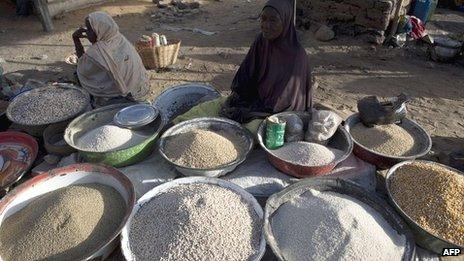 A woman waits for customers in a market in the northern city of Gao, on 13 March 2013
