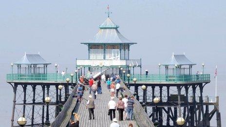 People enjoy warm weather on the Victorian Pier at Clevedon, North Somerset.