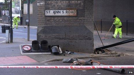 Workers clear the scene on where two men died following a police chase