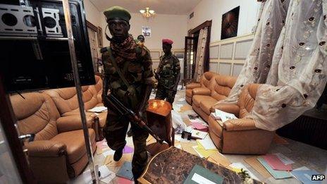 Seleka rebels look around the pillaged office of deposed president Francois Bozize in Bangui on March 28, 2013.