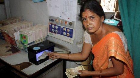 Seema Fokle with the machine that detects forged notes
