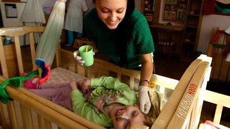 A volunteer interacts with a child in an orphanage in Russia