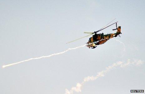 A Syrian attack helicopter fires a rocket on exercises (file image)
