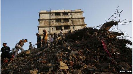 Rescue workers search through the rubble of a collapsed building in Thane, 5 April 2013