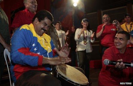 Nicolas Maduro plays a drum while on the campaign trail in the state of Bolivar, Venezuela, 6 April