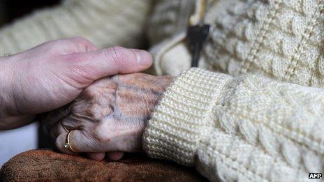 Close-up of somebody holding and elderly lady's hand