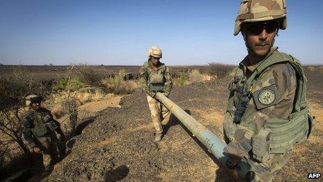 French soldiers from the 92nd Infantry Regiment carry a rocket in the Gao region on 7 April 2013