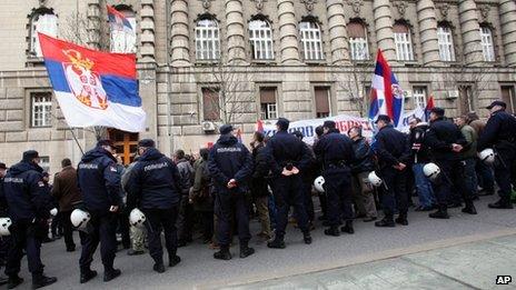 Protesters wave Serbian flags during a protest of Serbian nationalists in front of the government building in Belgrade, Serbia, 8 April 2013