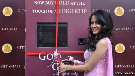 Indian Bollywood actress Raima Sen poses during an event to promote an ATM which dispenses gold and silver coins in Mumbai
